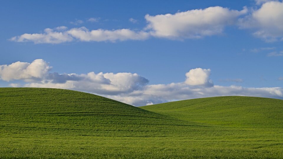 The rolling green agricultural hills of The Palouse in Colton, Washington, captured during the golden hour with dramatic highlights and shadows.