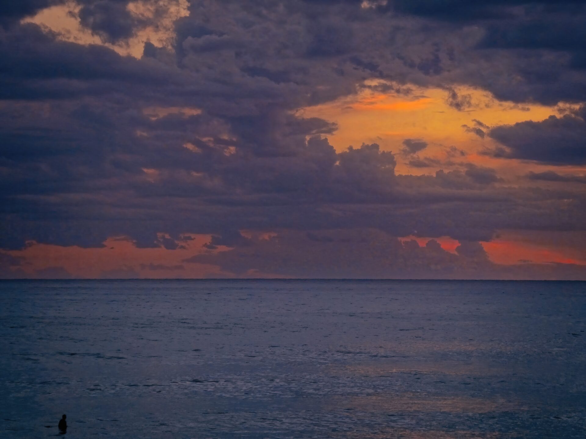 Lone Figure in Sunset Sea