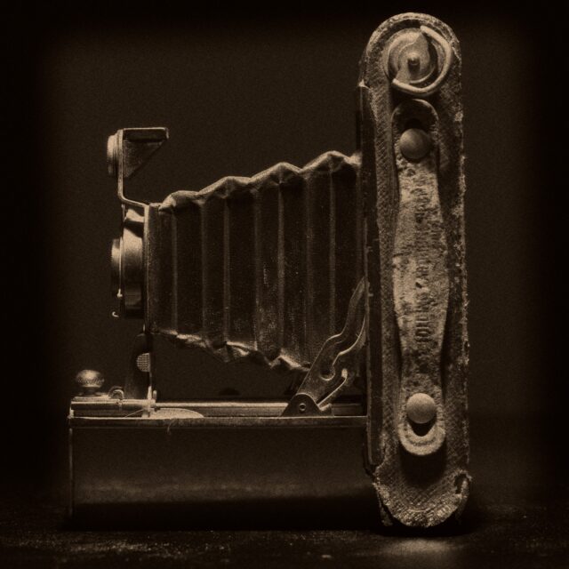 Vintage folding camera still life photograph taken in a home studio