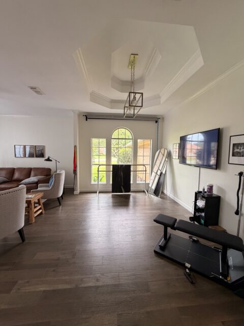 Living room converted to workout space that doubles as a home photo studio