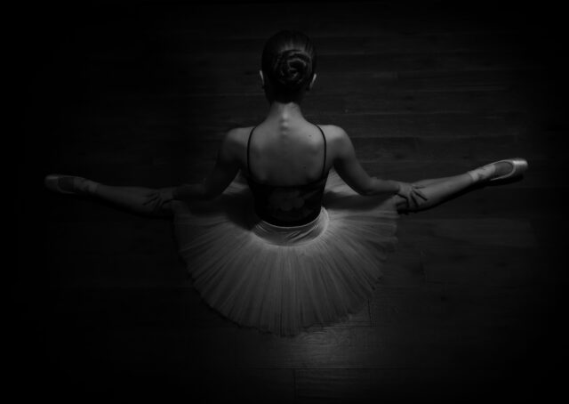 Overhead black and white photo of a ballet dancer in a tutu taken in a home studio