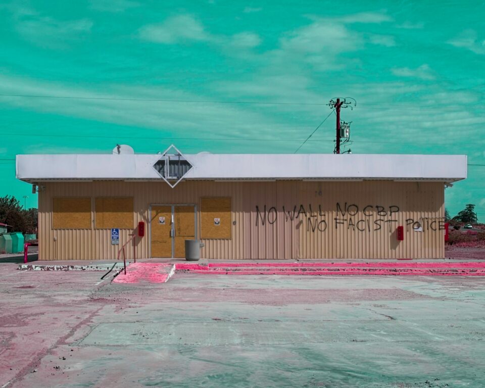 A boarded-up Marfa, Texas storefront edited in ON1 Photo RAW with a pop-art false-color look of pink and teal