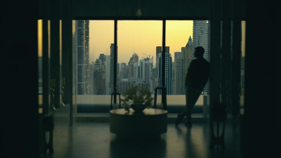 Same skyline window after the Amber & Aqua LUT, with teal shadows and a warm amber sky