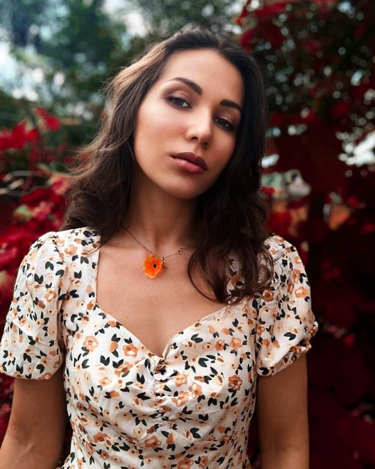 Same portrait after the Bloom LUT, with the foliage turned deep red and natural skin tones