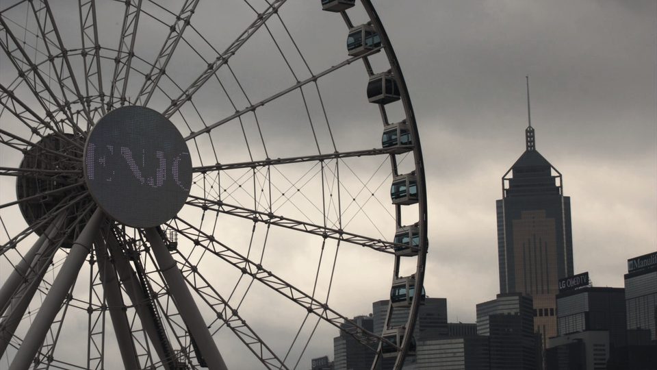 Same Ferris wheel scene after the Dark & Moody LUT, with a darker, warmer, moodier sky