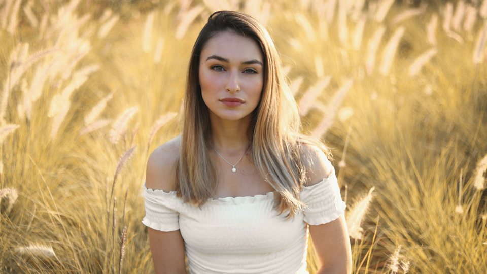 Same portrait after the Honey Glow LUT, with softer skin and a warm, creamy glow